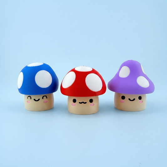 Three spotted mushroom fidget clickers in blue, red and purple