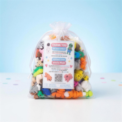 Random Pack organza bag of 30 Mini Printies on a sky-blue studio backdrop