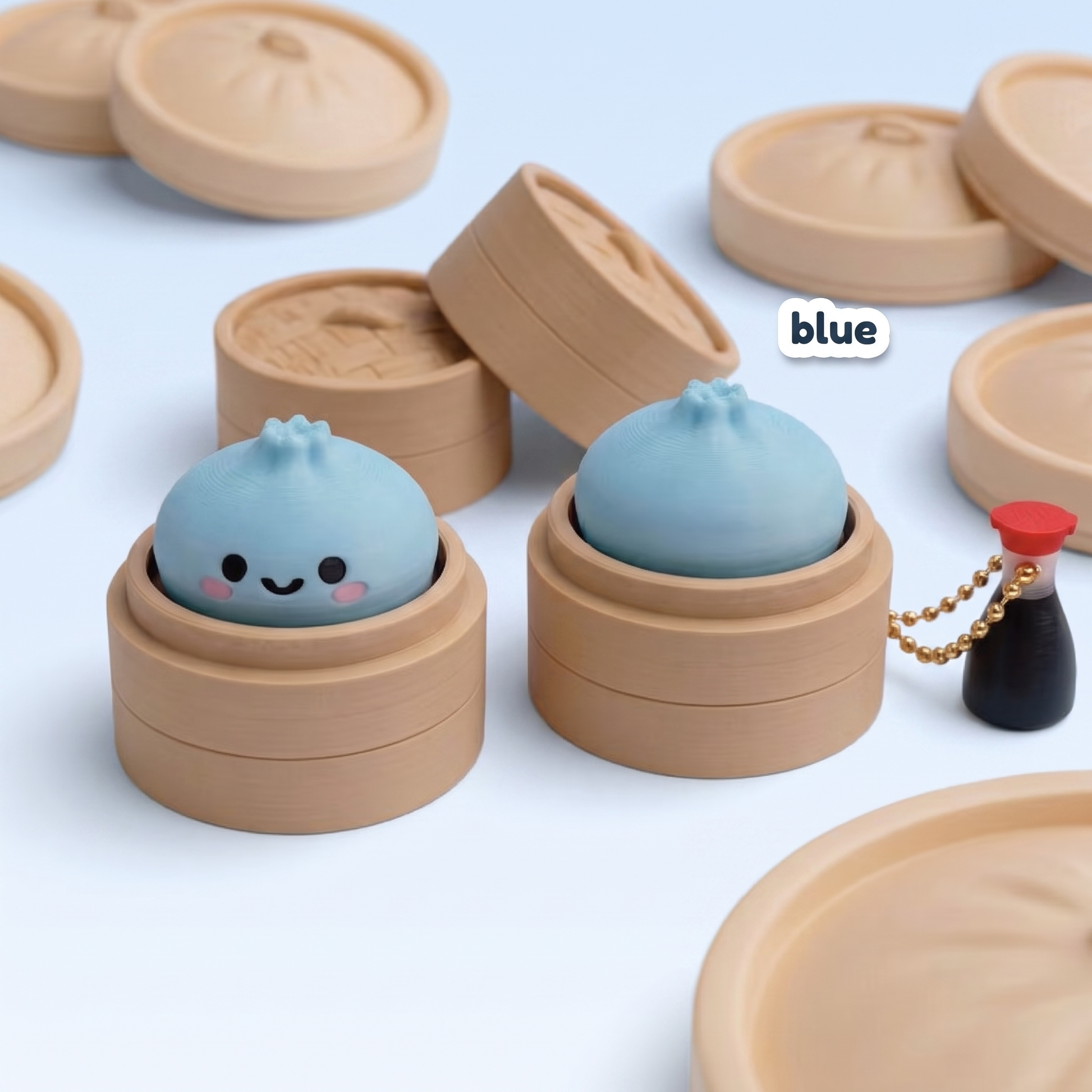 Blue Dumpling Fidget Clicker keychain in its steamer basket