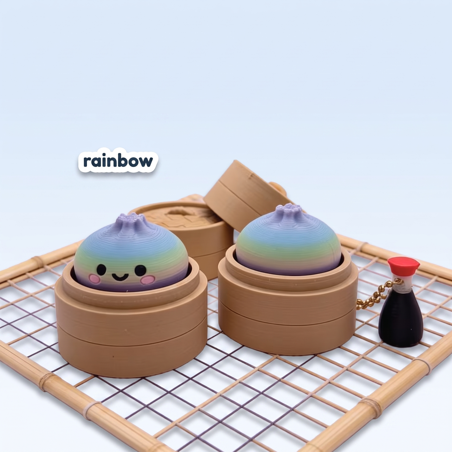 Rainbow gradient Dumpling Fidget Clicker keychain in its steamer basket