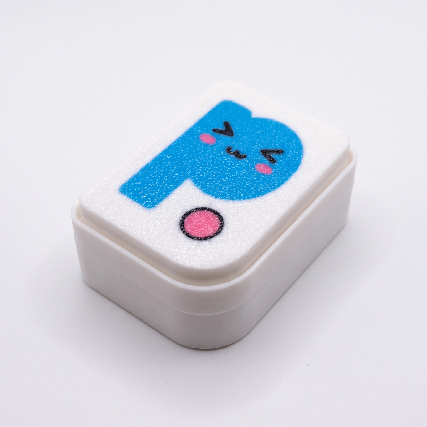 Printies Clicker — white fidget clicker with kawaii Printies P logo top