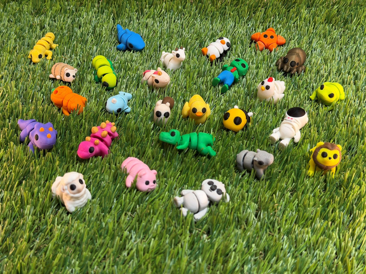 A real spread of Mini Printies on grass — the kind of mix you get in a Random Pack
