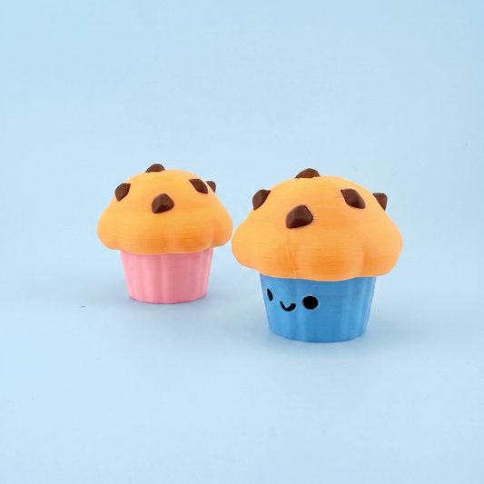Two 3D printed muffin fidget clickers with pink and blue cupcake cases