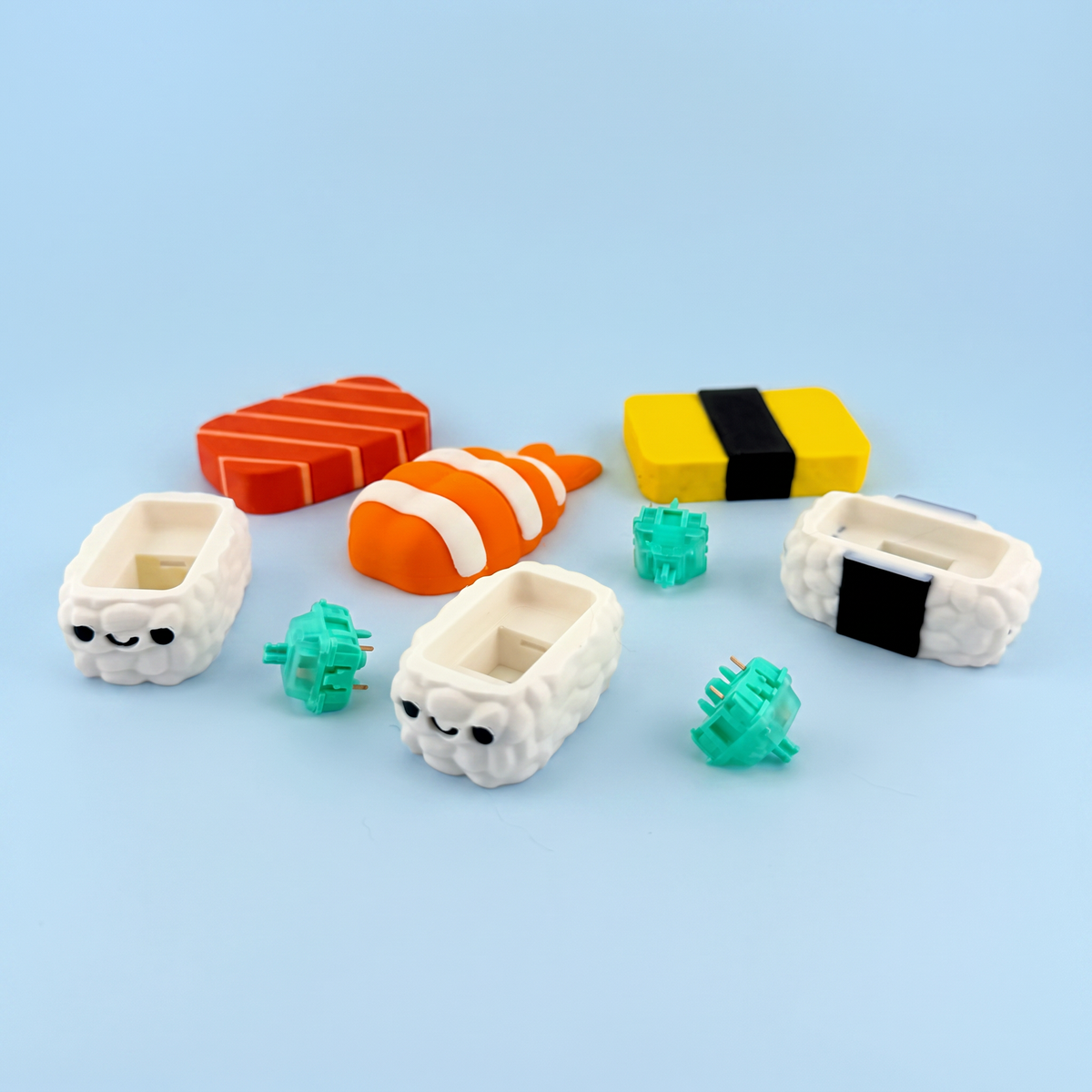 Nigiri clicker parts laid out - printed toppings, rice bases and the mechanical switches inside