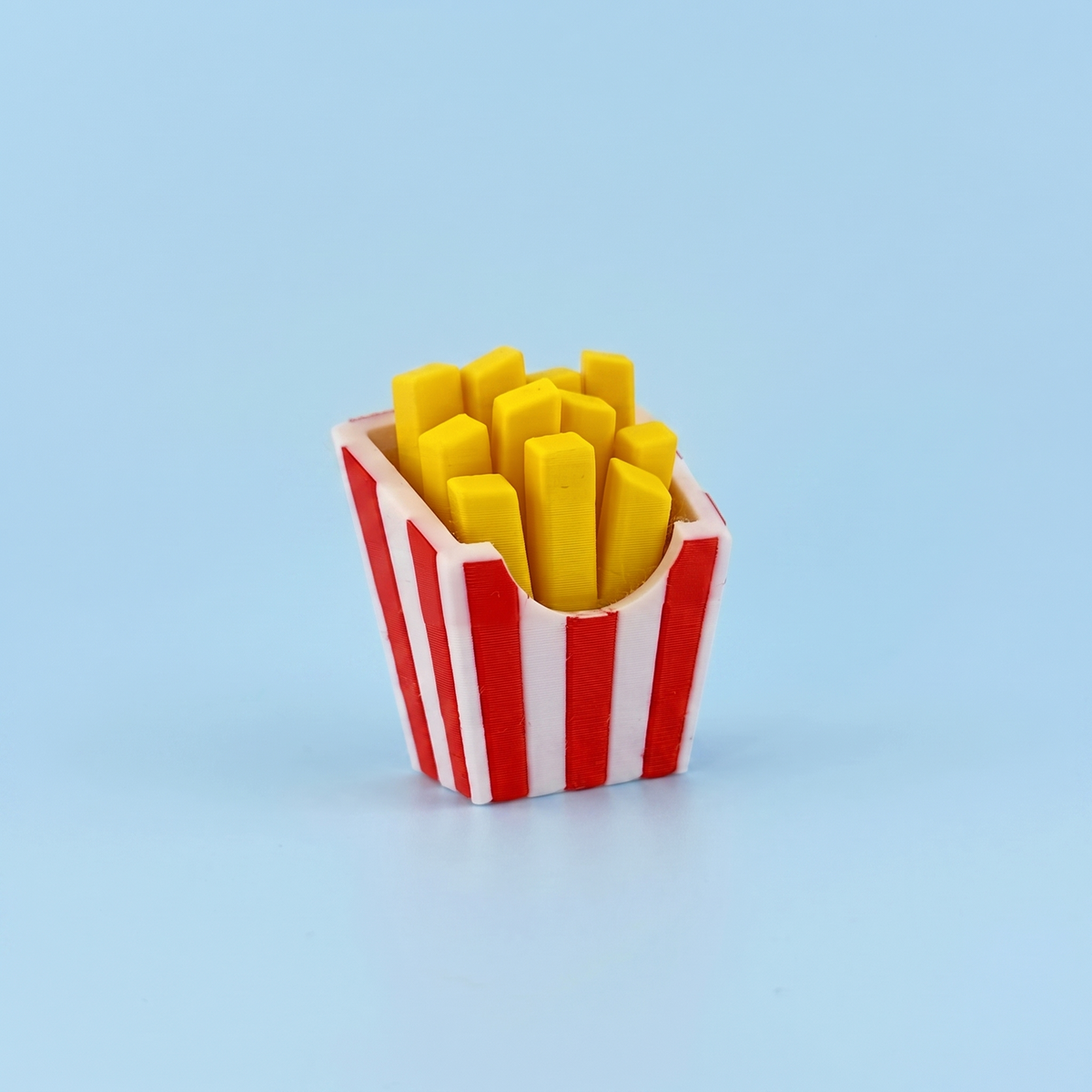 French fries fidget clicker in a red and white striped carton