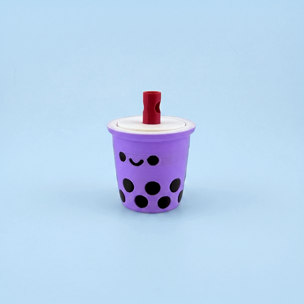 Single lilac bubble tea fidget clicker with a smiley face and boba pearls