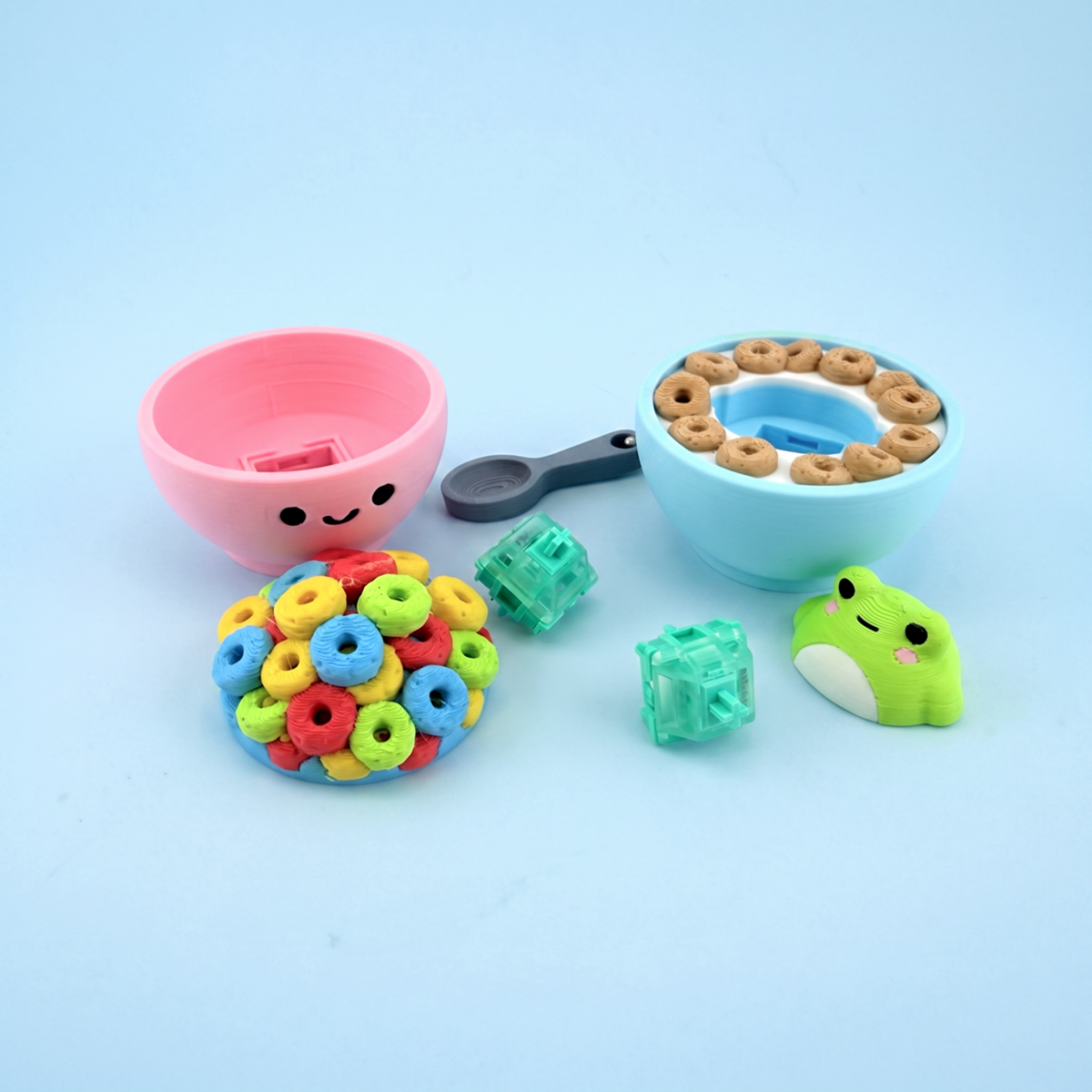 Cereal bowl clicker parts laid out - printed bowls, cereal caps and the mechanical switches inside