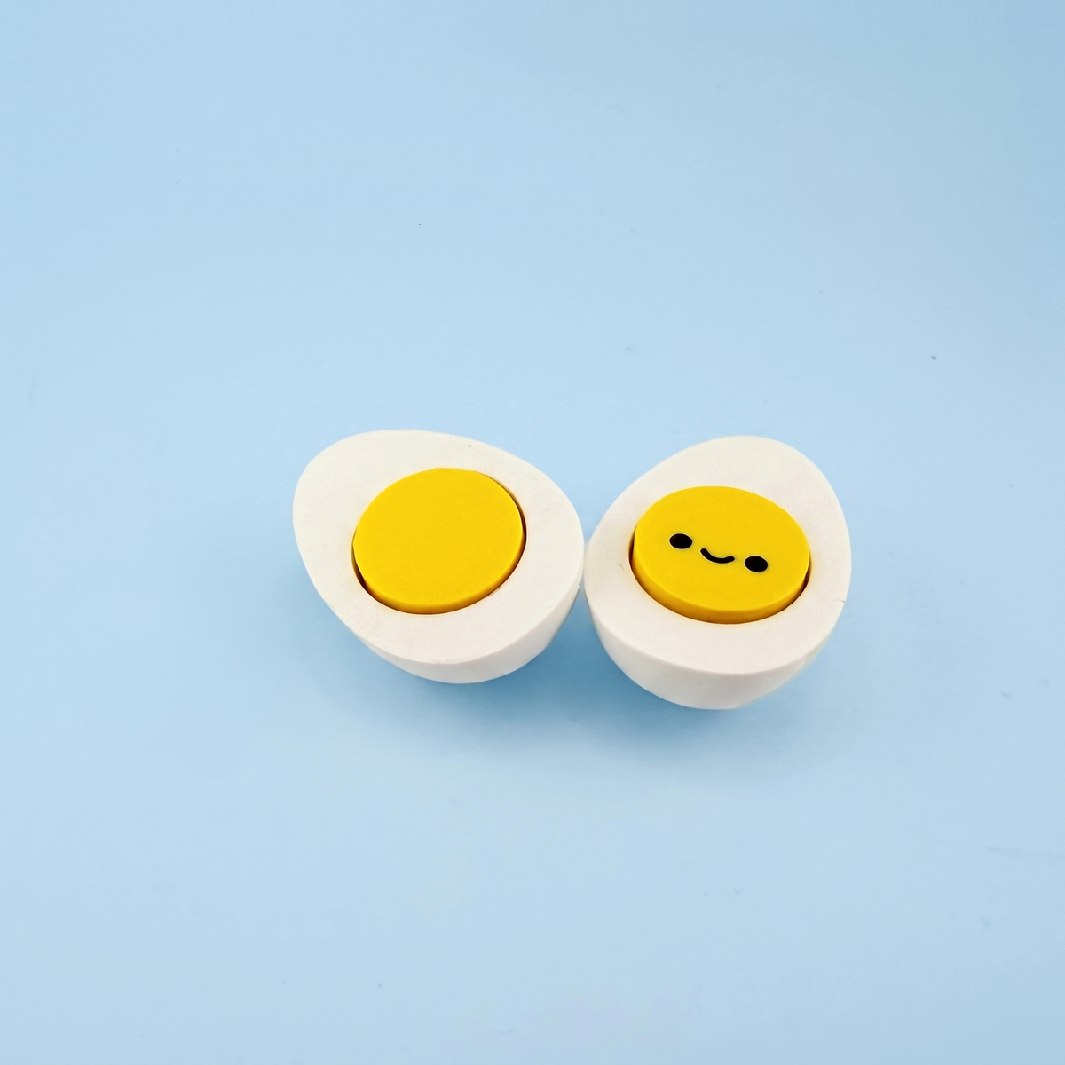 Hard-boiled egg fidget clickers with pressable yellow yolks