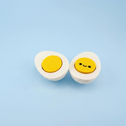Hard-boiled egg fidget clickers with pressable yellow yolks