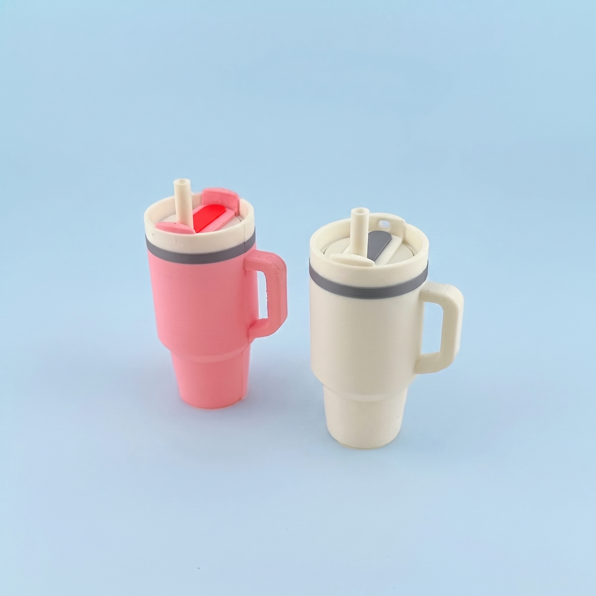 Pink and cream tumbler fidget clickers with flip lids and straws