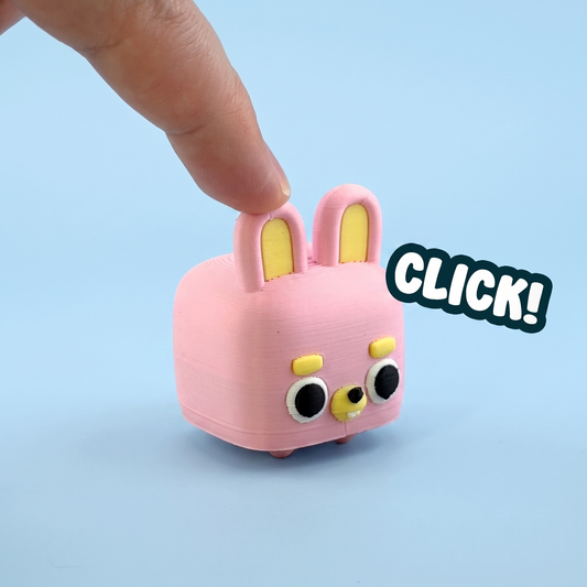 Pink bunny mini pet fidget clicker being pressed with a click