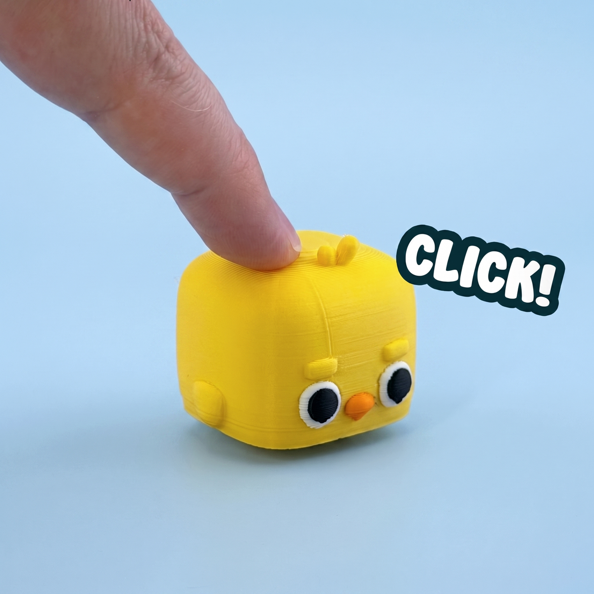 Yellow chick mini pet fidget clicker being pressed with a click