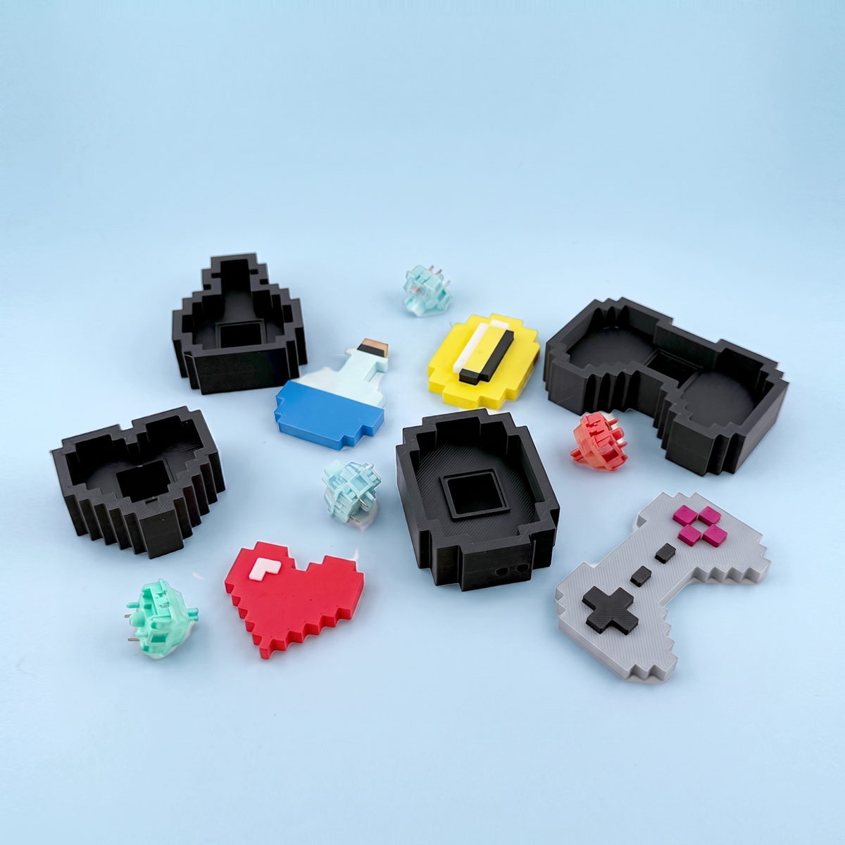 Retro game clicker parts laid out - printed icons, bases and the mechanical switches inside