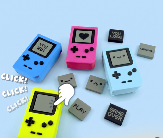 Pocket console fidget clickers with swappable pixel screens, being pressed with a click