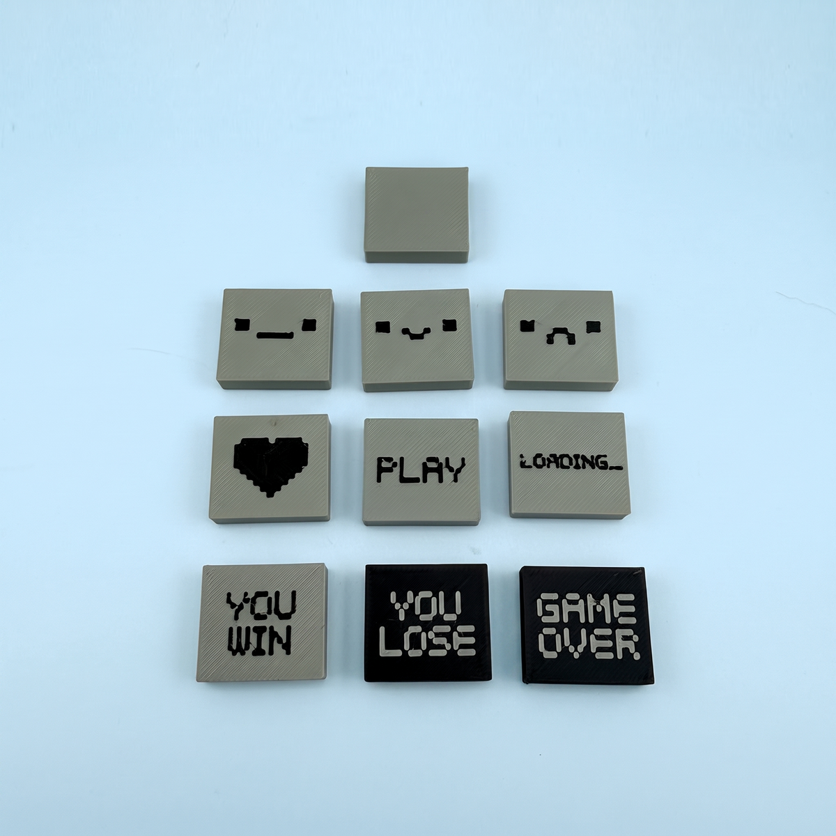 The ten swappable pixel screen tiles - faces, heart, PLAY, LOADING, YOU WIN, YOU LOSE and GAME OVER