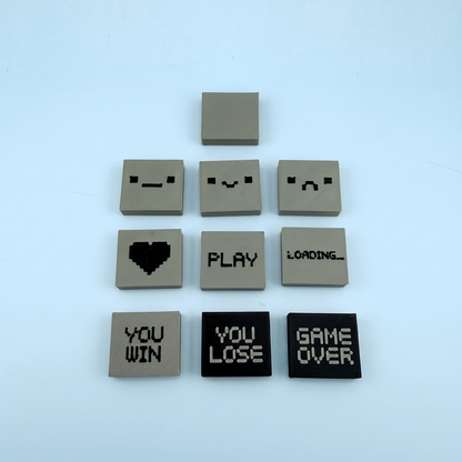 The ten swappable pixel screen tiles - faces, heart, PLAY, LOADING, YOU WIN, YOU LOSE and GAME OVER