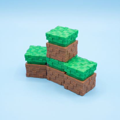 Grass block fidget clickers stacked in a staircase